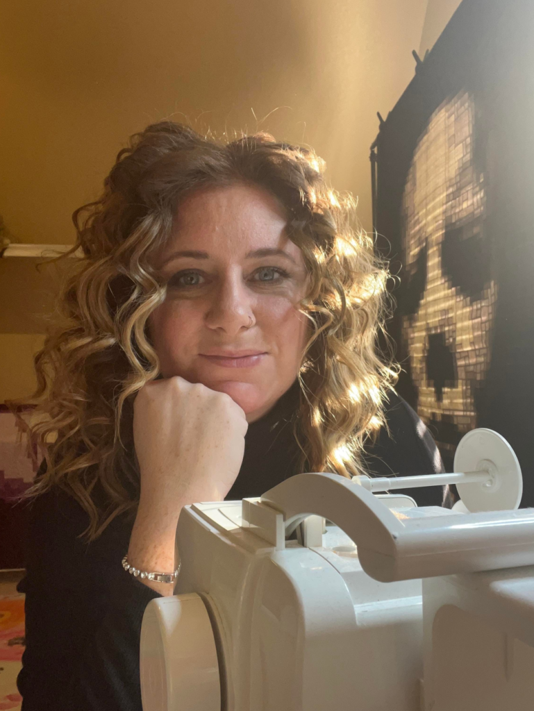 Woman sitting behind sewing machine